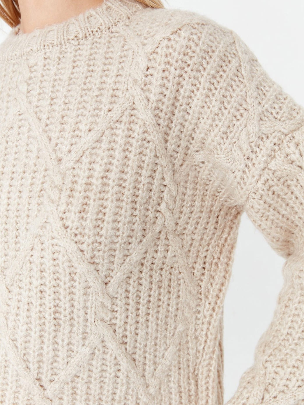 Rose cable-knit sweater texture detail
