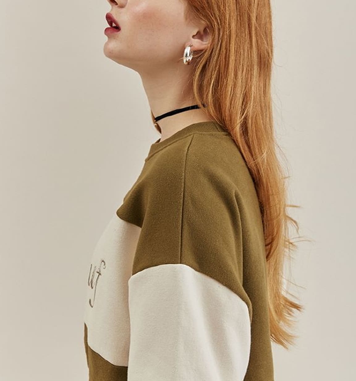 Model wearing a relaxed colour-block knit