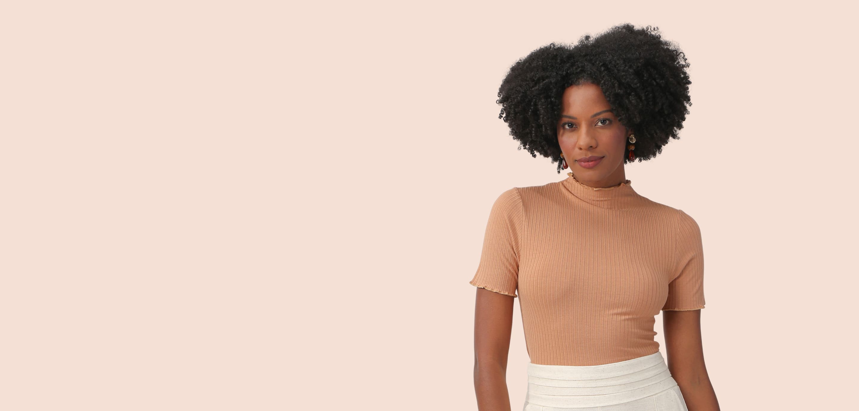 Woman wearing a warm neutral knit top